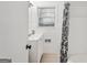 Bathroom with a vanity sink, tiled walls, and a shower/tub with patterned curtain at 2858 Valley Ridge Dr, Decatur, GA 30032