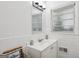 Bathroom featuring white vanity, sink, light fixture, and a window providing natural light at 2858 Valley Ridge Dr, Decatur, GA 30032