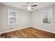Bedroom boasts beautiful hardwood floors, a ceiling fan, and two windows for ample light at 2858 Valley Ridge Dr, Decatur, GA 30032