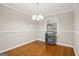 Well-lit dining room with hardwood floors, modern chandelier, and serving cart at 2858 Valley Ridge Dr, Decatur, GA 30032
