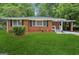 Charming brick home with a well-maintained lawn, covered carport, and traditional windows at 2858 Valley Ridge Dr, Decatur, GA 30032