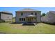 Home backyard featuring a patio, green grass, and a fenced perimeter at 3005 Nicholas Dr, Villa Rica, GA 30180