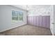 Neutral carpeted bedroom with wainscoting and a floral accent wall at 3005 Nicholas Dr, Villa Rica, GA 30180