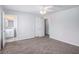 Bedroom with neutral carpet, closet, ceiling fan, and a bathroom entrance at 3005 Nicholas Dr, Villa Rica, GA 30180