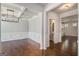 Beautiful dining room featuring hardwood floors, paneled walls, and a coffered ceiling with an adjacent powder room at 3005 Nicholas Dr, Villa Rica, GA 30180
