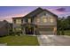 Two-story home with a brick facade, a two-car garage, and manicured landscaping at 3005 Nicholas Dr, Villa Rica, GA 30180