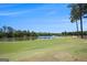 Scenic view of the lush green golf course and lake, surrounded by mature trees at 3005 Nicholas Dr, Villa Rica, GA 30180