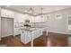 Modern kitchen featuring white cabinets, granite countertops, a large island, stainless steel appliances, and hardwood flooring at 3005 Nicholas Dr, Villa Rica, GA 30180