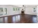 Open concept living room with hardwood floors, stone fireplace, French doors, and multiple large windows for great natural light at 3005 Nicholas Dr, Villa Rica, GA 30180