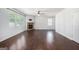Bright living room with hardwood flooring, a cozy stone fireplace, and large windows offering natural light and backyard views at 3005 Nicholas Dr, Villa Rica, GA 30180