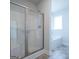 Modern bathroom featuring glass shower and a soaking tub at 267 Eason St, Bowdon, GA 30108