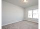 A carpeted bedroom featuring a bright window and neutral walls at 267 Eason St, Bowdon, GA 30108