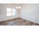 Bright dining area with hardwood floors, decorative wainscoting, and elegant lighting at 267 Eason St, Bowdon, GA 30108
