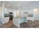 Bright, spacious kitchen featuring white cabinets, stainless steel appliances, and center island at 267 Eason St, Bowdon, GA 30108