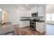 Kitchen showcasing granite countertops, stainless steel appliances, and crisp white cabinetry at 267 Eason St, Bowdon, GA 30108