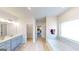Relaxing bathroom featuring a soaking tub, double vanity, and natural light at 263 Eason St, Bowdon, GA 30108