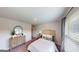 Comfortable bedroom with a decorative mirror and window at 263 Eason St, Bowdon, GA 30108