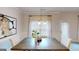 Cozy dining area with a modern light fixture and natural light coming through sheer curtains at 263 Eason St, Bowdon, GA 30108