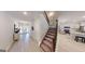Bright foyer with staircase leading to the second floor and views of the kitchen at 263 Eason St, Bowdon, GA 30108