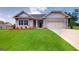 Charming single-story home with manicured lawn and beautiful flower beds at 263 Eason St, Bowdon, GA 30108