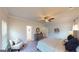 Serene bedroom with a ceiling fan, accent chair, and a stylish dresser at 263 Eason St, Bowdon, GA 30108