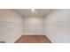 Spacious walk-in closet featuring a single row of metal shelving and brown carpet flooring at 263 Eason St, Bowdon, GA 30108