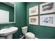 Stylish powder room featuring a pedestal sink, modern fixtures, and elegant wall decor at 1402 Grand Branch Dr, Lawrenceville, GA 30045
