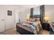 A cozy bedroom with superhero-themed bedding, patterned curtains and a neutral color palette at 1402 Grand Branch Dr, Lawrenceville, GA 30045
