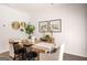 Dining area showcasing a wooden table, black chairs, decorative wall accents, and a modern aesthetic at 1402 Grand Branch Dr, Lawrenceville, GA 30045