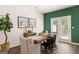 Bright dining area with hardwood floors, stylish furnishings, and access to the outdoors through glass doors at 1402 Grand Branch Dr, Lawrenceville, GA 30045
