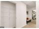 Hallway view featuring a closet and a glimpse of a bedroom with a bench seat at 1402 Grand Branch Dr, Lawrenceville, GA 30045