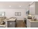 Bright kitchen featuring an island, stainless steel appliances, and wood floors at 1402 Grand Branch Dr, Lawrenceville, GA 30045