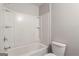 Bathroom with a white shower-tub combination and white toilet at 2137 Chadwick Sw Rd, Atlanta, GA 30331