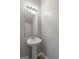 Powder room featuring a pedestal sink, large mirror, and modern fixtures at 2137 Chadwick Sw Rd, Atlanta, GA 30331