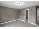 Bedroom features a neutral paint, hardwood floors, and trim with a door at 2137 Chadwick Sw Rd, Atlanta, GA 30331