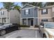 Two-story townhouse featuring a dark gray facade, black door, and adjacent parking at 2137 Chadwick Sw Rd, Atlanta, GA 30331