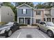 Two-story townhouse featuring a dark gray facade, black door, and adjacent parking at 2137 Chadwick Sw Rd, Atlanta, GA 30331