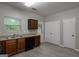 Kitchen with wooden cabinets, stainless steel sink, and gray floors at 2137 Chadwick Sw Rd, Atlanta, GA 30331