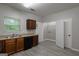 Well-lit kitchen featuring wood cabinets, stainless steel sink and black appliances at 2137 Chadwick Sw Rd, Atlanta, GA 30331