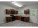 Kitchen with wooden cabinets, black appliances, gray floors, and a view of the backyard at 2137 Chadwick Sw Rd, Atlanta, GA 30331