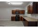 Modern kitchen with granite countertops, wood cabinetry, and black appliances at 2137 Chadwick Sw Rd, Atlanta, GA 30331