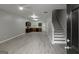 Open-concept living area with gray floors, leading to a kitchen and staircase at 2137 Chadwick Sw Rd, Atlanta, GA 30331
