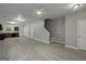 Large living room with gray floors, staircase and kitchen at the back at 2137 Chadwick Sw Rd, Atlanta, GA 30331