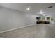 Spacious living room with gray floors leading to a kitchen at 2137 Chadwick Sw Rd, Atlanta, GA 30331