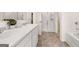 Spacious bathroom featuring double sinks, marble countertops, and a bathtub at 1404 Gray Branch Dr, Lawrenceville, GA 30045