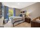 Bedroom featuring a large window with patterned curtains, side table with a lamp, and a dresser at 1404 Gray Branch Dr, Lawrenceville, GA 30045
