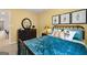 Comfortable bedroom with decorative pillows, yellow walls, and dark wooden dresser with round mirror at 1404 Gray Branch Dr, Lawrenceville, GA 30045