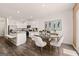 A bright eat-in kitchen features stainless appliances, an island with seating, and a stylish dining table at 1404 Gray Branch Dr, Lawrenceville, GA 30045