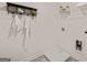 Modern laundry room with overhead storage, wire shelving, utility sink, and white walls at 1404 Gray Branch Dr, Lawrenceville, GA 30045