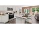 Spacious living area featuring white kitchen with granite countertops, barstool seating, and dining nook at 1404 Gray Branch Dr, Lawrenceville, GA 30045